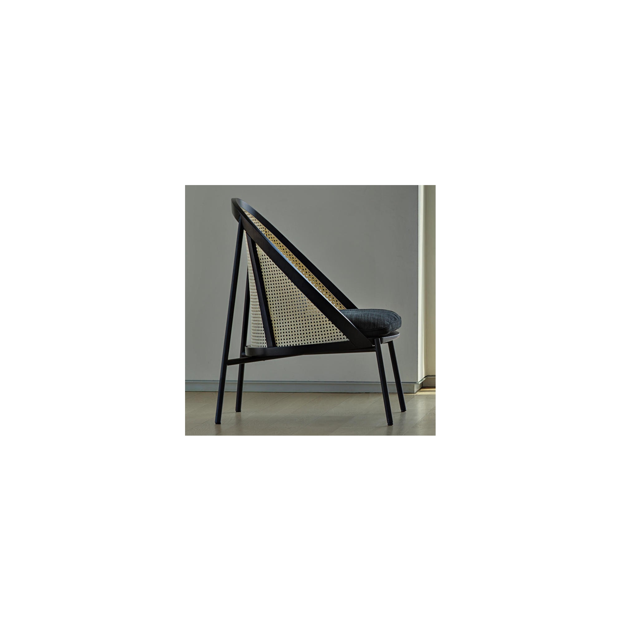 Loïe lounge chair - black lacquered ash, Raas fabric colour 172, woven cane backrest